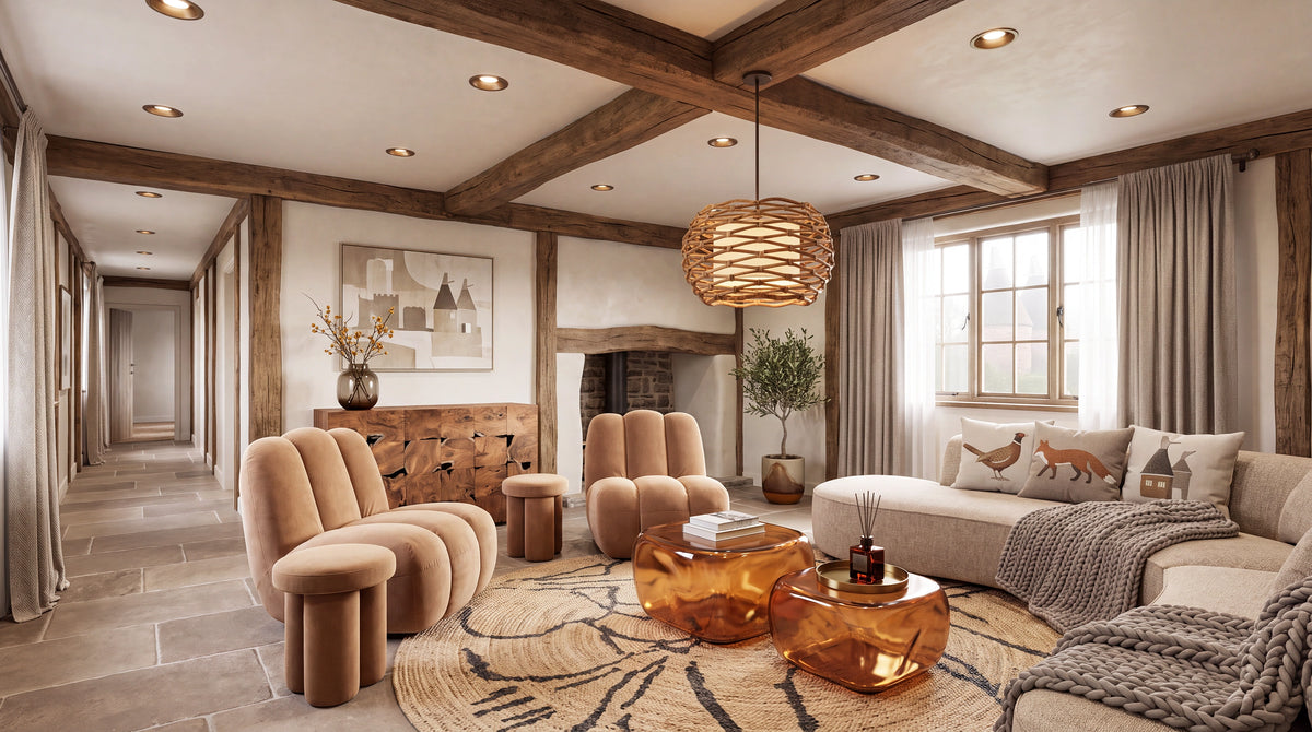A luxury rustic living room featuring a beige sectional sofa, two round tufted armchairs, amber glass coffee tables, a woven wicker pendant light, and a stone fireplace under a wooden-beamed ceiling.