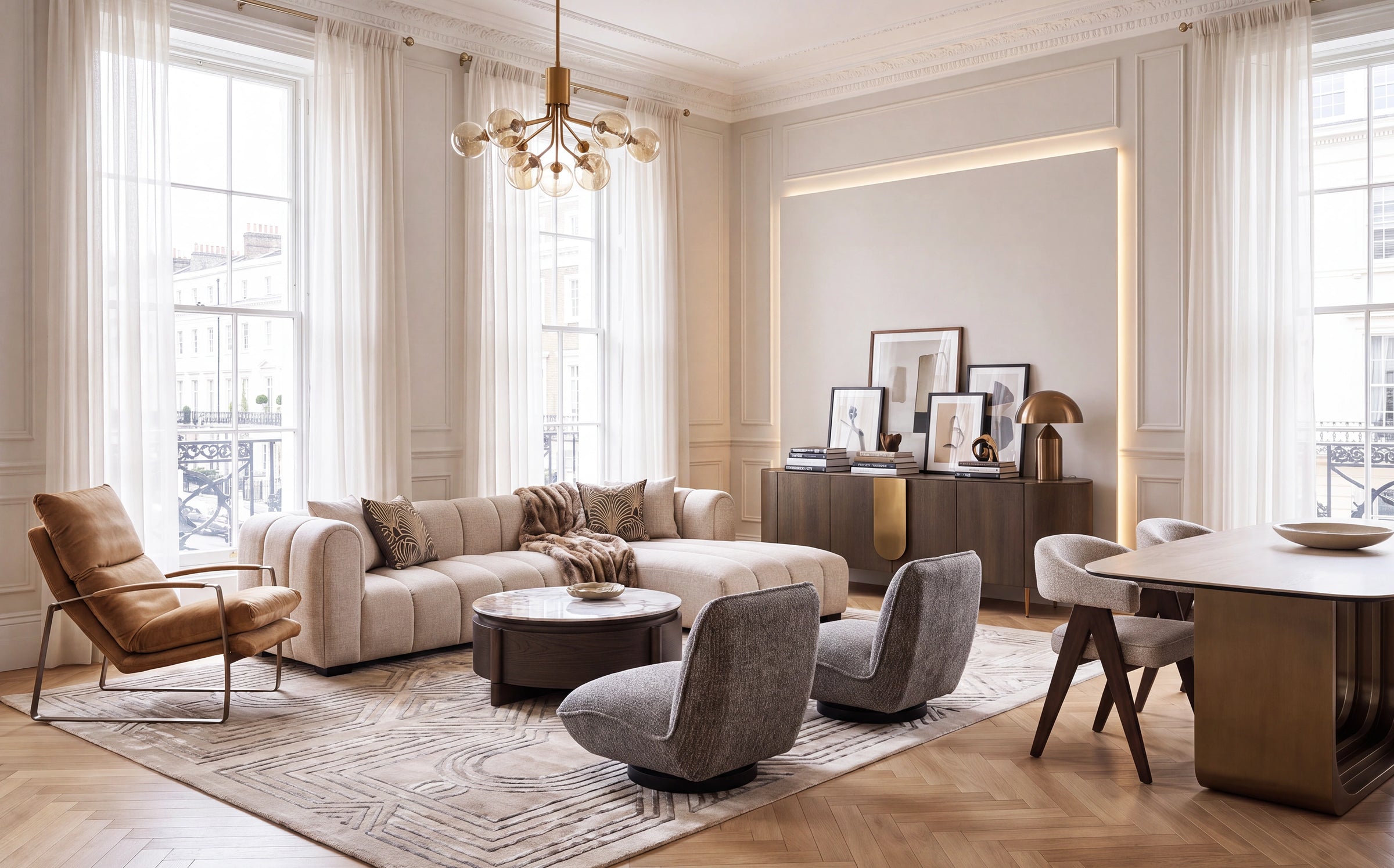 A luxury modern living room featuring a beige sectional sofa, two gray accent chairs, a brown leather armchair, a round coffee table, and a dining set on a patterned rug, set in a bright room with tall windows and sheer curtains.